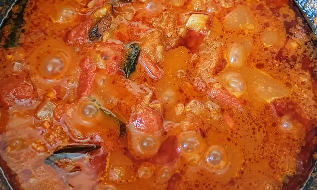 Curry sauce simmering in a pot