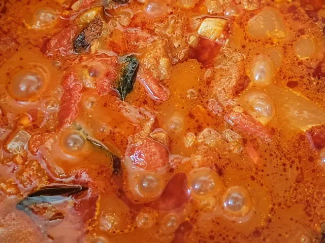 Curry sauce simmering in a pot