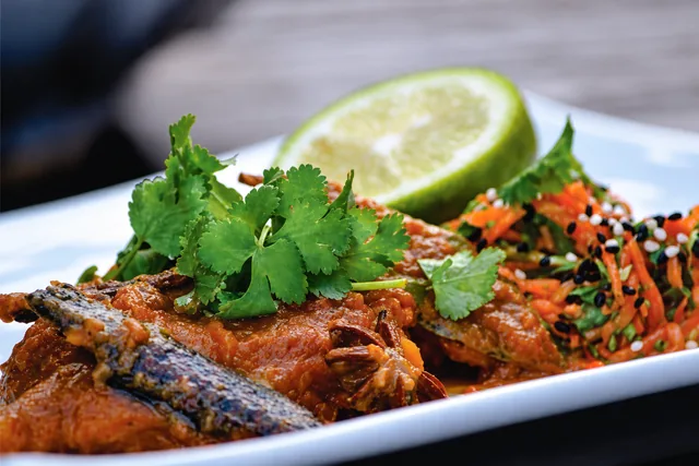 Dean Dickinson’s pickled fish garnished with herbs and lime