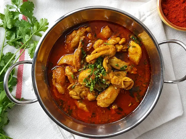Durban chicken curry with potatoes in a serving bowl