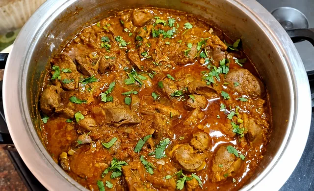 Durban chicken liver curry garnished with fresh herbs