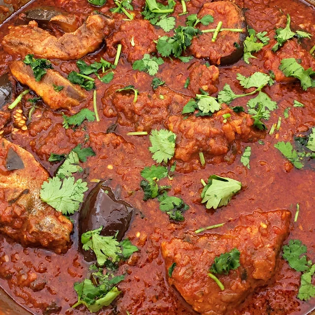 Durban fish curry in a red sauce with fresh herbs