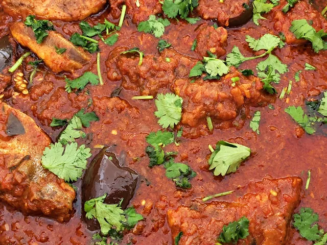 Durban fish curry in a red sauce with fresh herbs