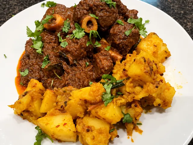Lamb knuckle rogan josh served with yellow rice