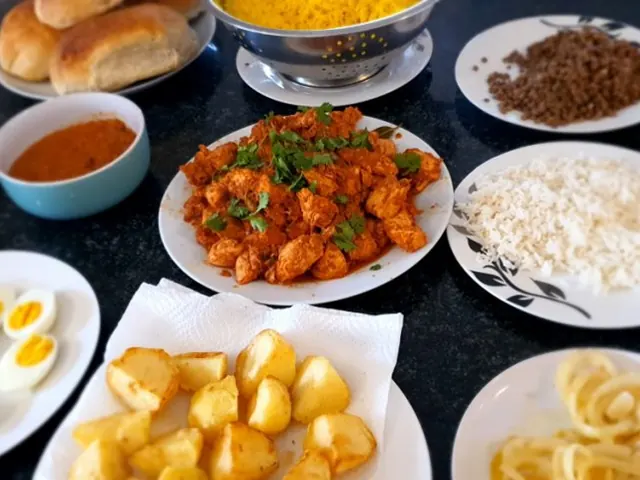 Chicken breyani ingredients ready for layering, including rice, potatoes and eggs