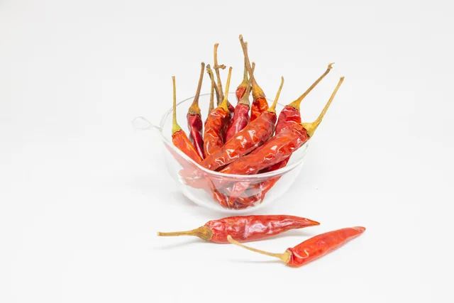 Dried red chillies in a clear glass bowl.