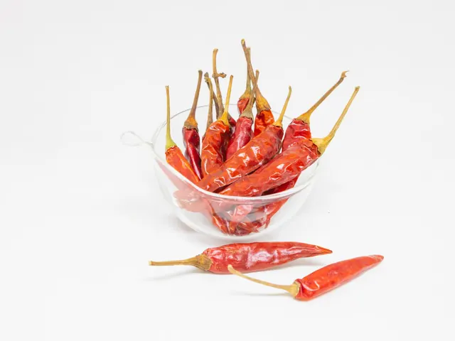 Dried red chillies in a clear glass bowl.