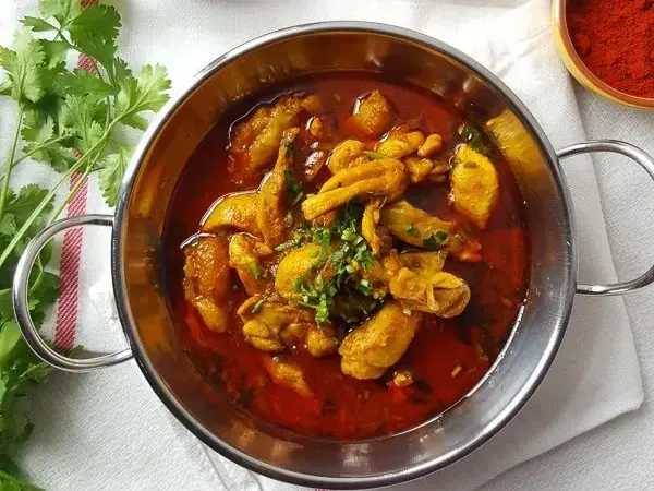 Durban chicken curry with potatoes in a serving bowl