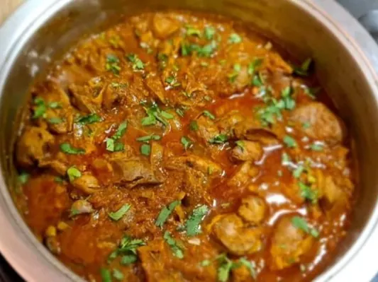 Durban chicken liver curry garnished with fresh herbs