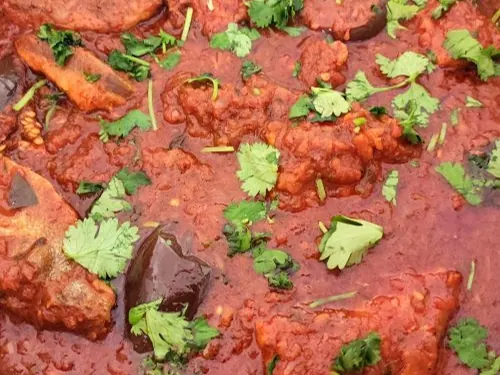 Durban fish curry in a red sauce with fresh herbs