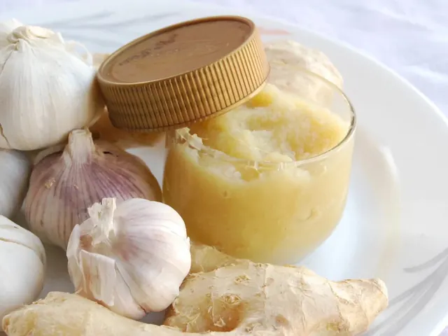 Garlic and ginger paste in a jar beside garlic bulbs