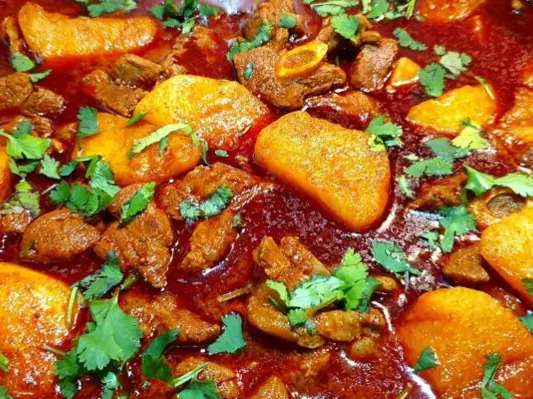 Golden potatoes in mutton curry