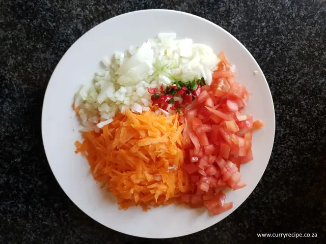 Grated carrot, chopped tomato and onion for carrot salad sambals