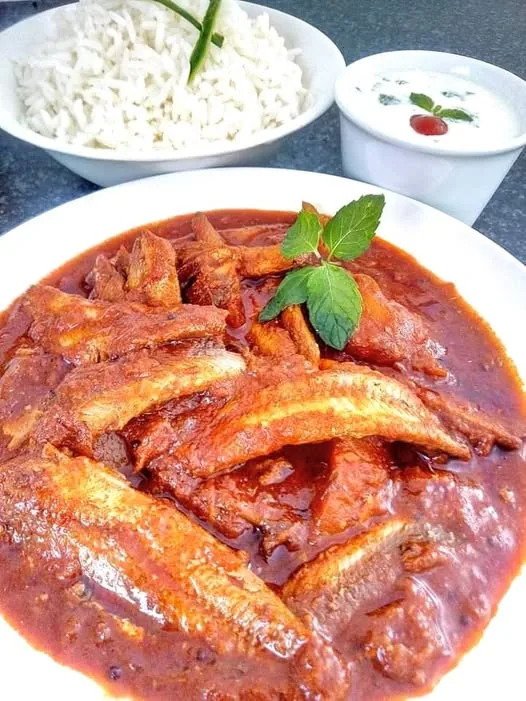 Irene’s tinfish curry with potatoes in tomato gravy, served alongside rice