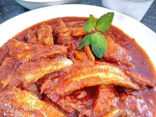 Irene’s tinfish curry with potatoes in tomato gravy, served alongside rice