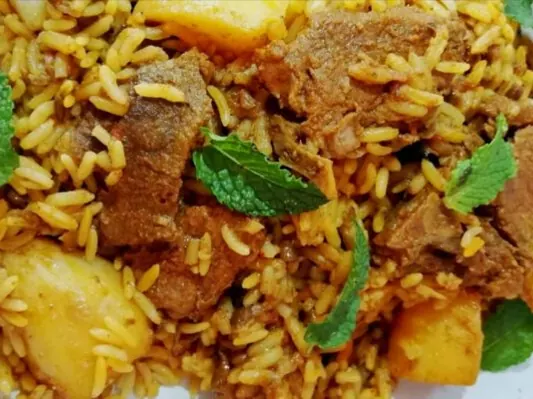 Lamb masala breyani with rice and fresh herbs
