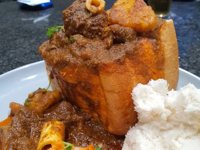 Mutton bunny chow served with carrot salad