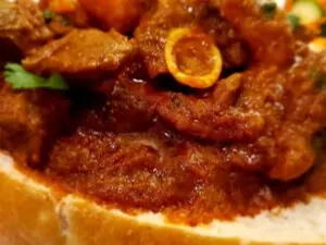 Mutton curry served in sourdough bread