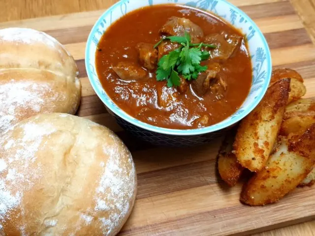 Peri-peri chicken giblets with bread rolls and potato wedges