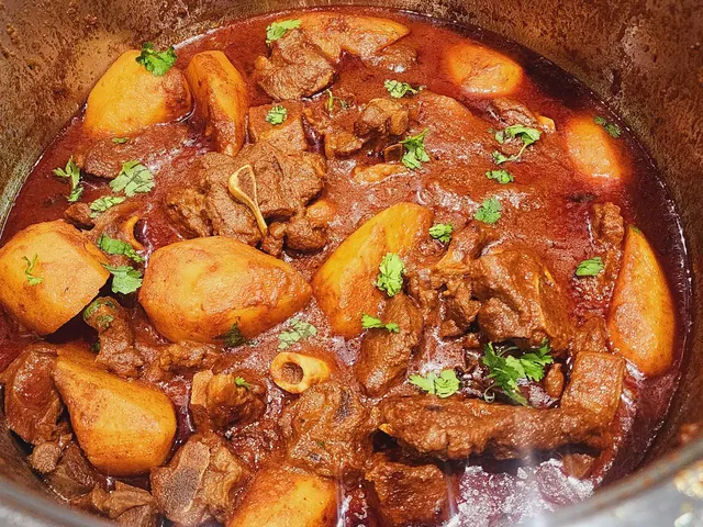 Shane’s mutton curry with potatoes and fresh coriander in the cooking pot