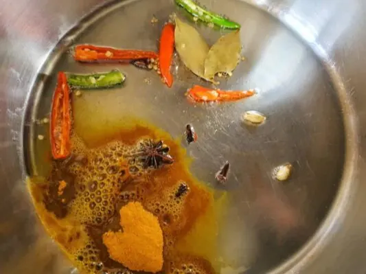 Whole spices and chillies tempering in oil